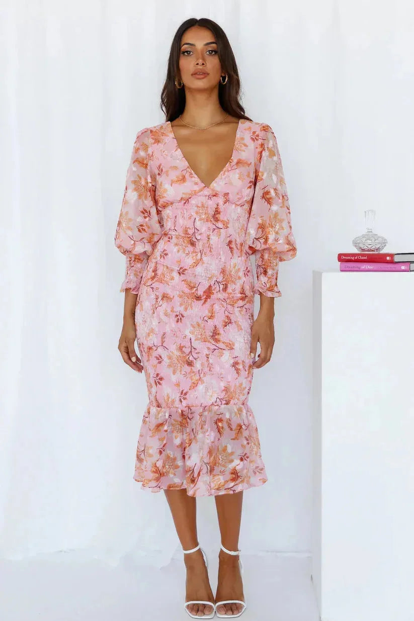 Floral midi dress with sleeves showcasing an elegant design perfect for any occasion.