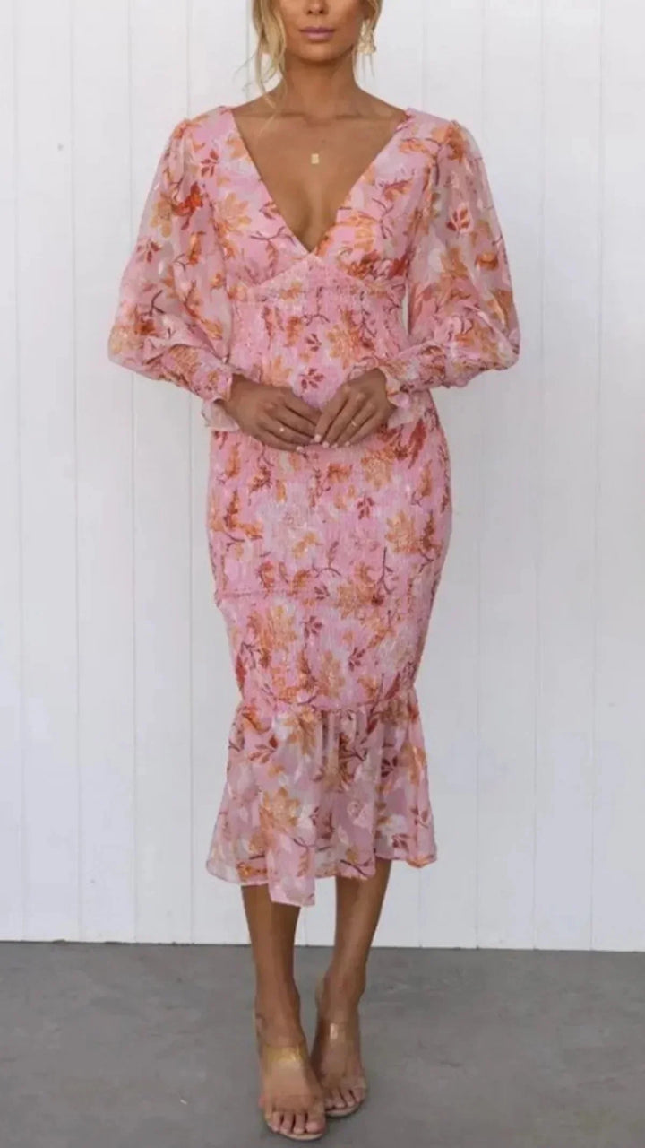 "Floral midi dress with sleeves, featuring an elegant design perfect for any occasion."