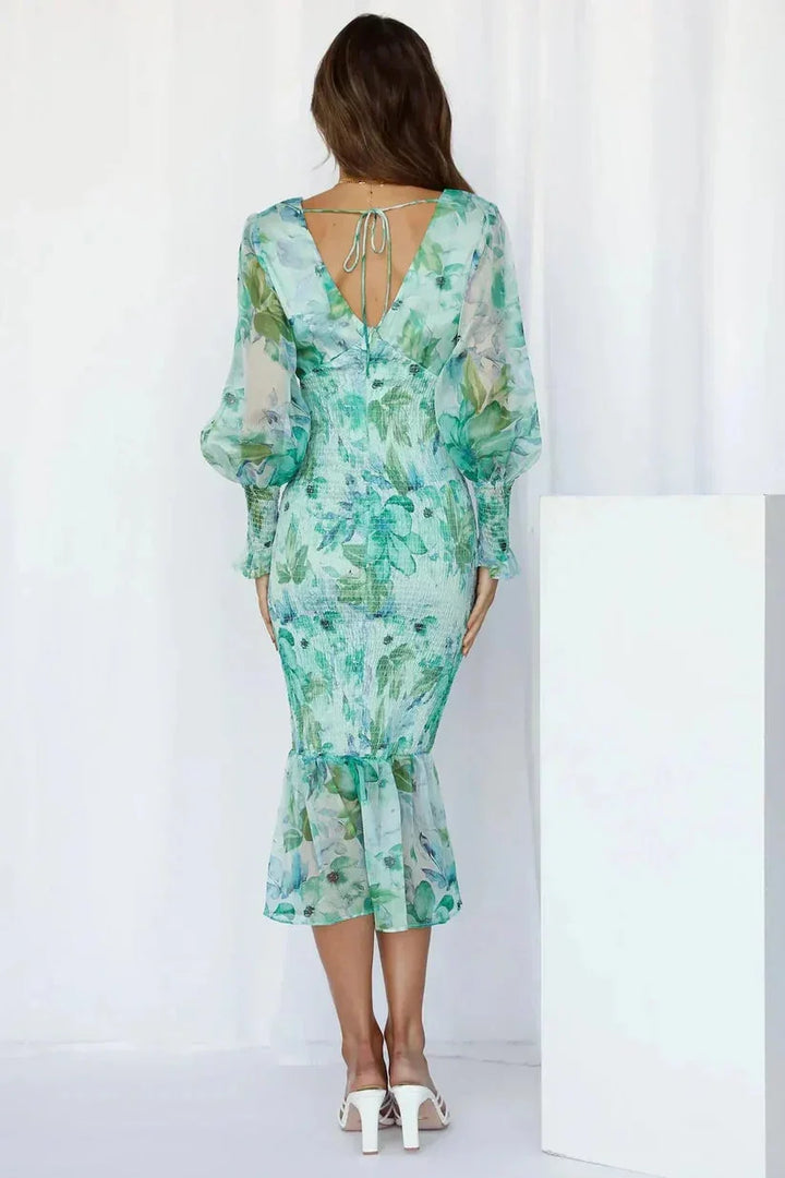 Floral-patterned midi dress with sleeves, a tasteful blend of elegance and sophistication.