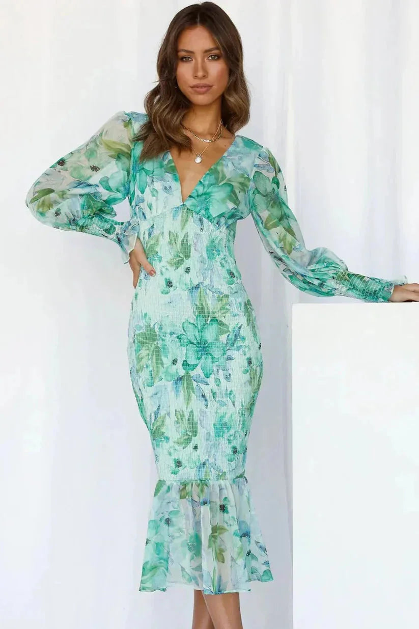 Green midi dress with sleeves, featuring elegant floral print. Made from soft fabric.