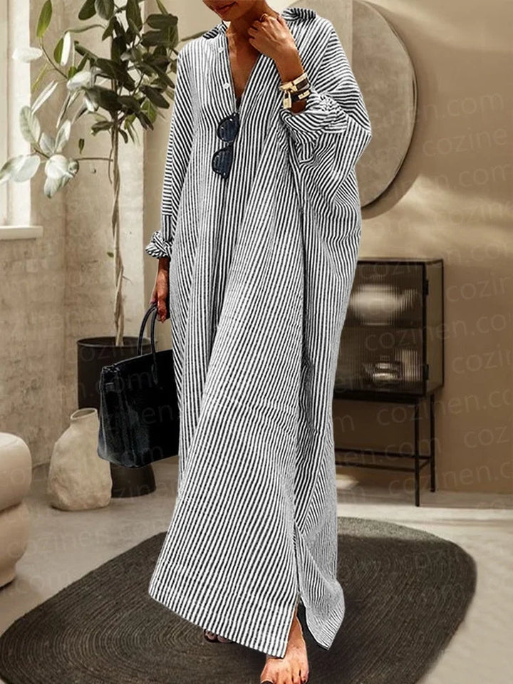 Black striped dress and oversized cardigan set in cozy knit fabric. Perfect for layered styling, featuring a chic matching…