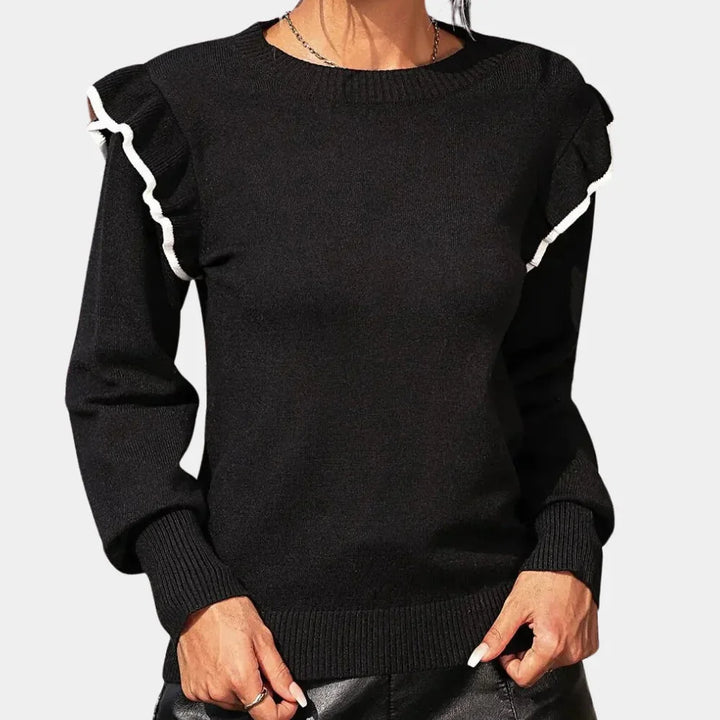 Black crewneck sweater with chic ruffle trim detailing. Made of soft, cozy material for a stylish and comfortable everyday…