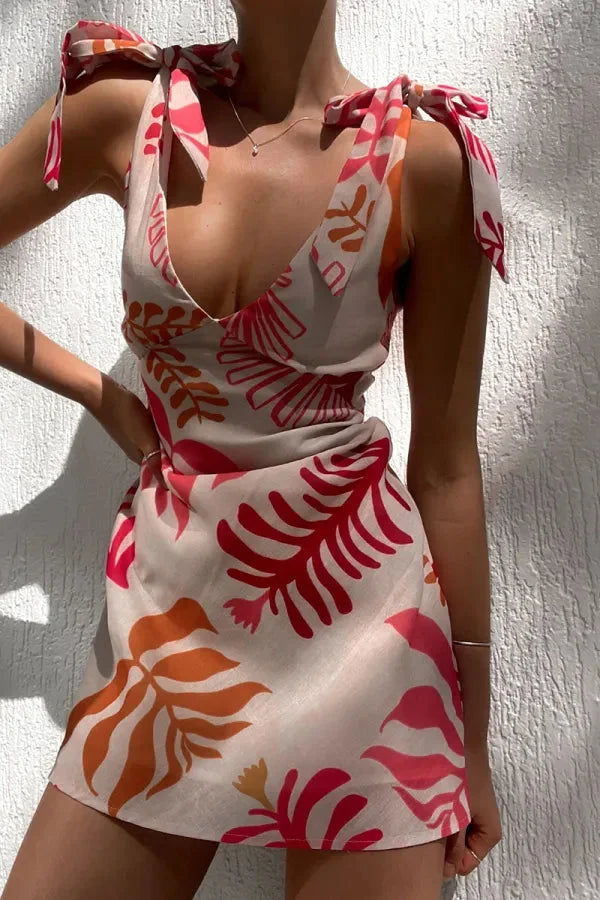 Red floral print V-neck mini dress made of soft cotton blend fabric. Perfect for a casual day out or summer gatherings.