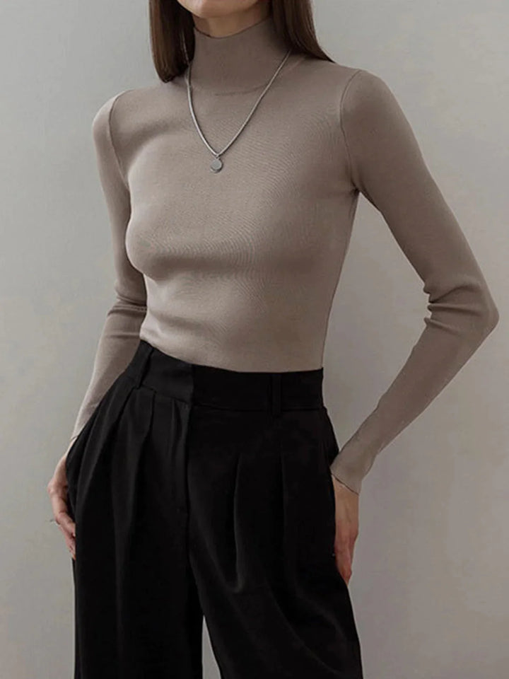 Camel seamless turtleneck with versatile styling, perfect for layering. Smooth texture in a warm neutral hue.