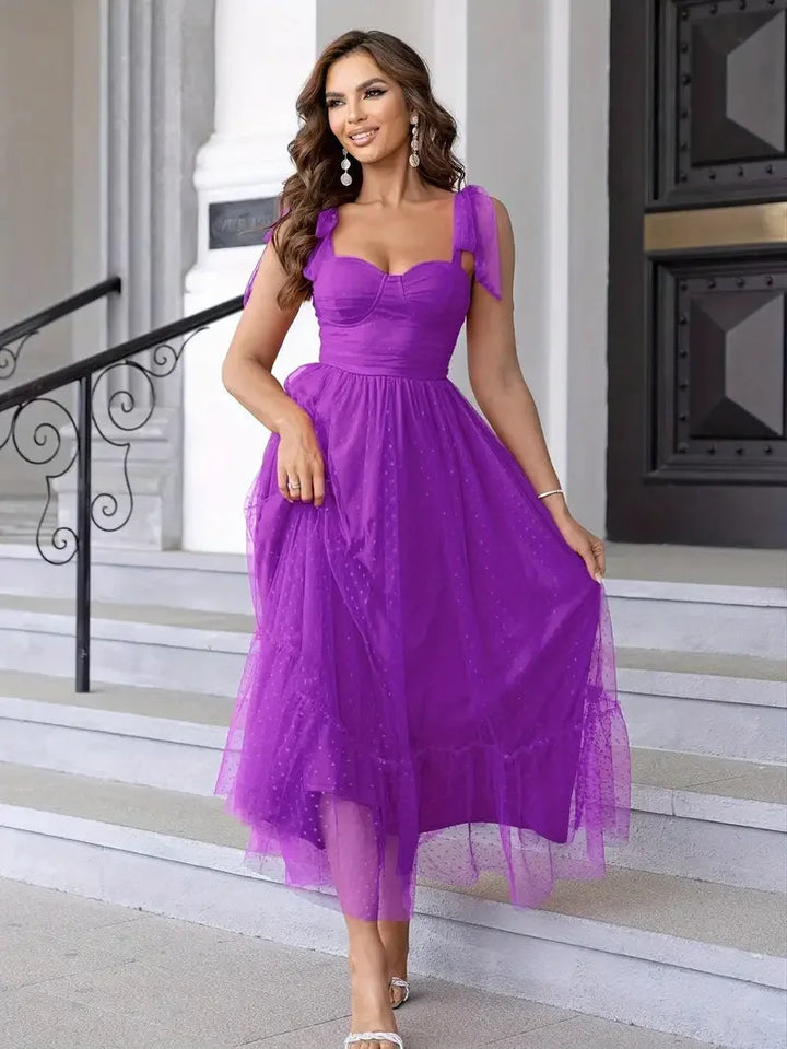Purple sleeveless dress with white polka dots pattern, mid-length. Made of lightweight, breathable fabric perfect for casual…