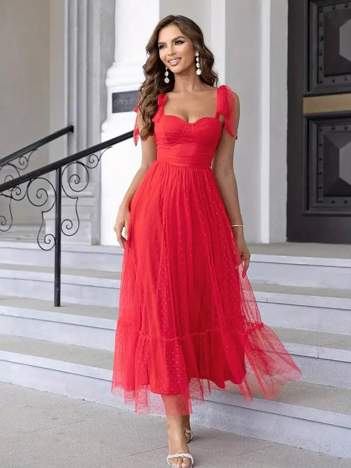 "Sleeveless red dress with white dots, mid-length, perfect for casual outings. Comfortable and stylish."