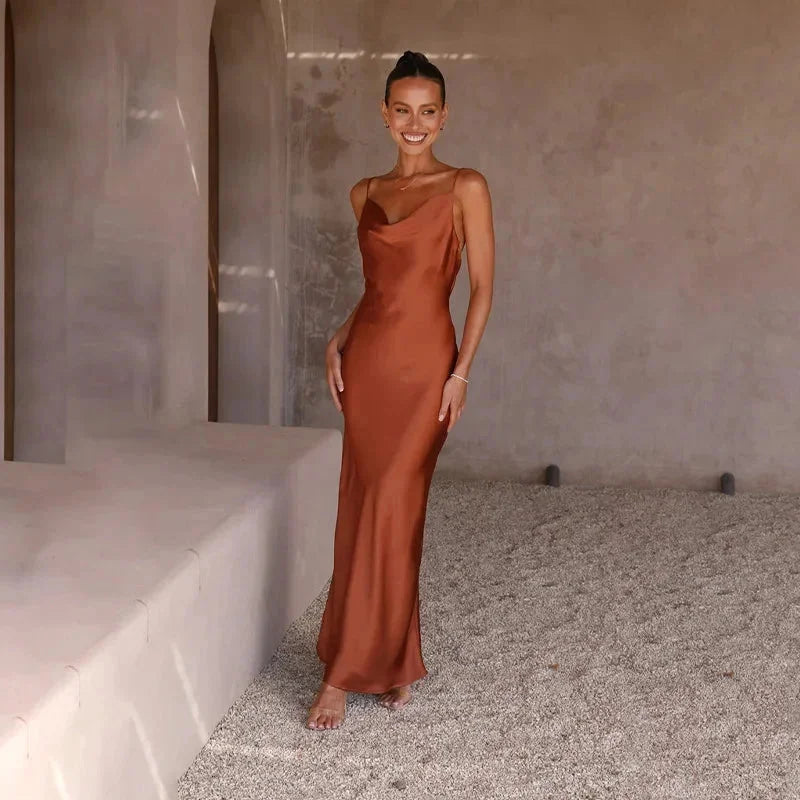"Sleeveless maxi dress in soft blush fabric with elegant cowl neckline"
