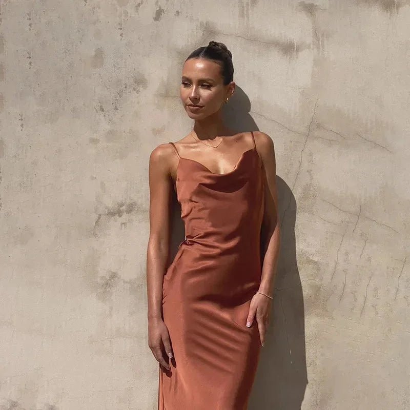 Sleeveless maxi dress in navy blue with cowl neckline, perfect for summer events or weekend outings.