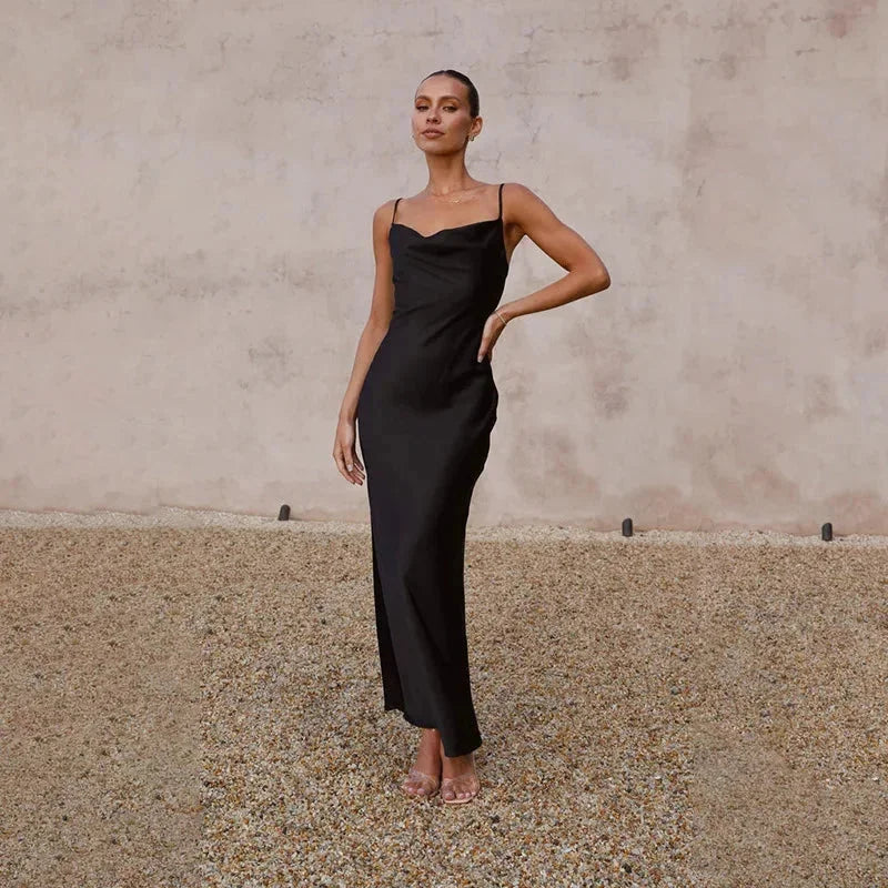 Black sleeveless maxi dress with cowl neckline. Features a flowy and elegant design, perfect for any occasion.