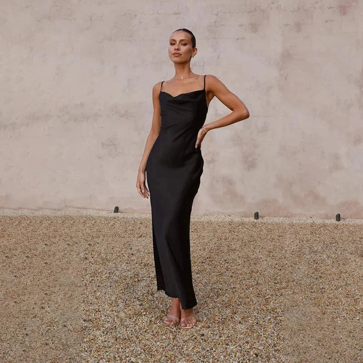 Black sleeveless maxi dress with cowl neckline. Features a flowy and elegant design, perfect for any occasion.