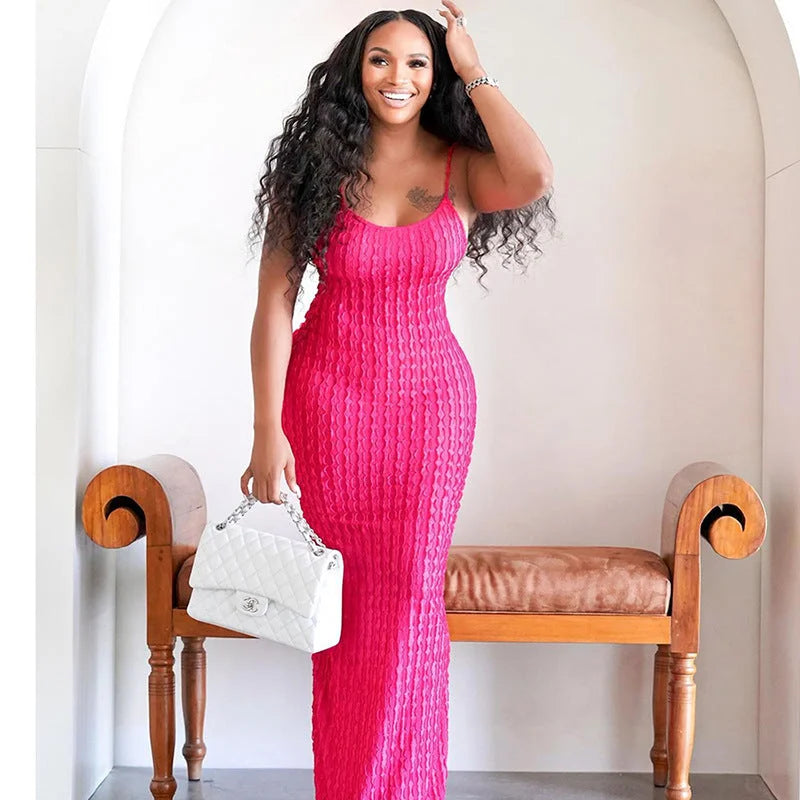 Pink lace maxi dress hugging the body with elegance, ideal for women.