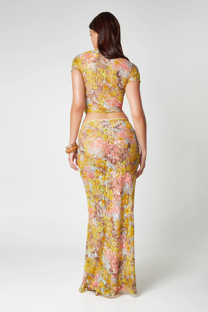 "Yellow floral print co-ord set featuring a midi skirt and matching top with a trendy design."