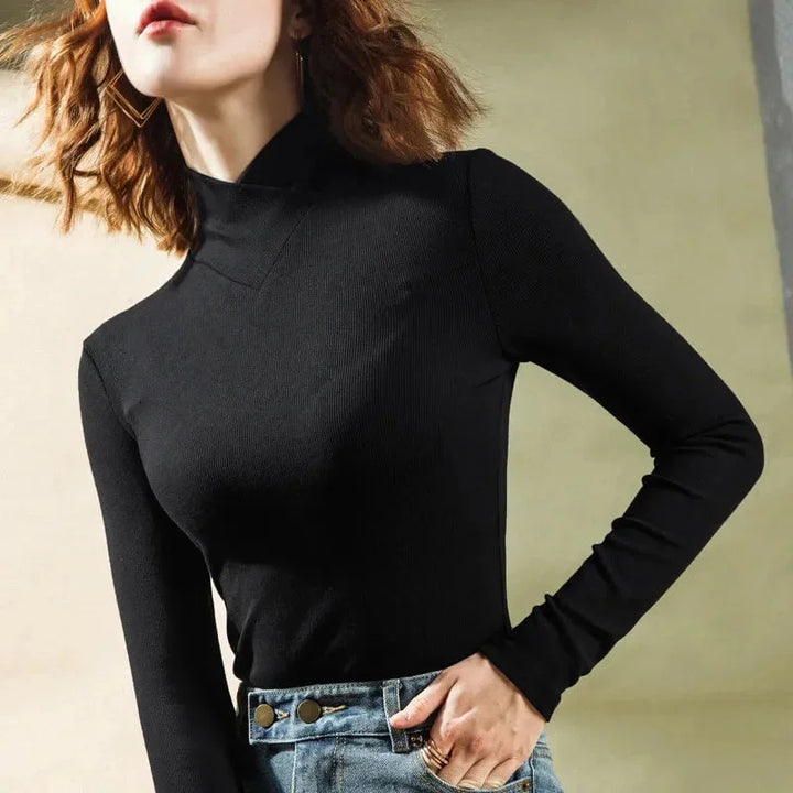 "Black high-collar top with slim-fit design and seamless construction, ideal for versatile styling."