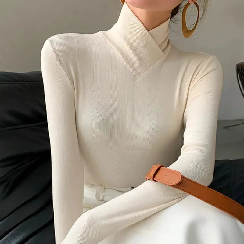 Cream white slim-fit high-collar top featuring seamless design. Made from ultra-soft, stretchy fabric for a comfortable fit.