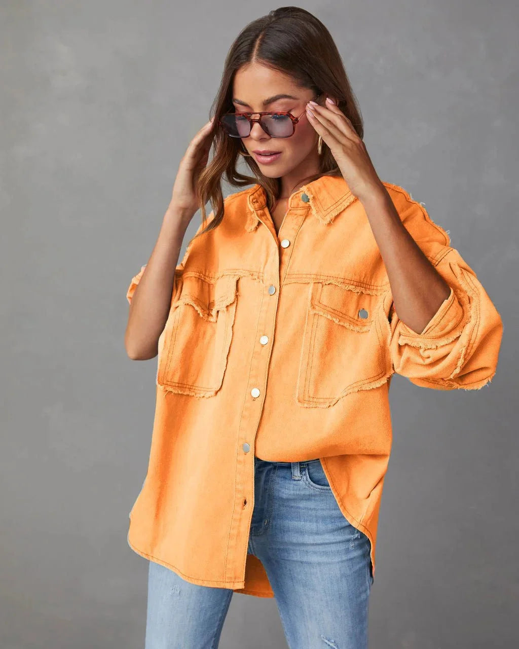 "White cotton blouse with two chest pockets, designed with a relaxed fit and button-up front, perfect for everyday wear."