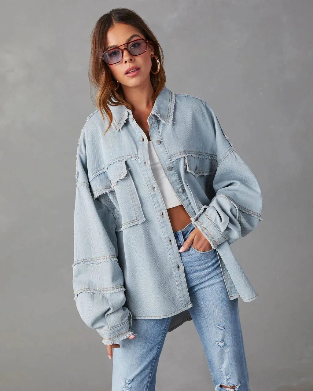 Blue cotton blouse with chest pockets, casual and versatile design for everyday wear.