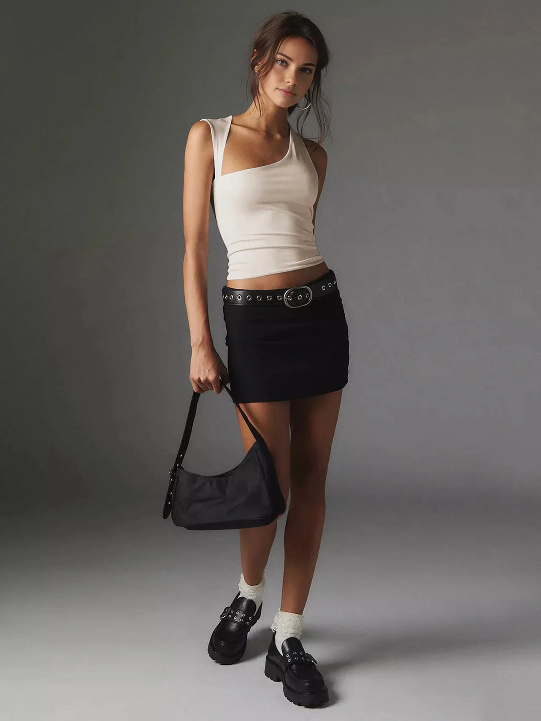 "Sleeveless scoop neck top in soft organic cotton blend, form-fitting silhouette with unique stitching detail"