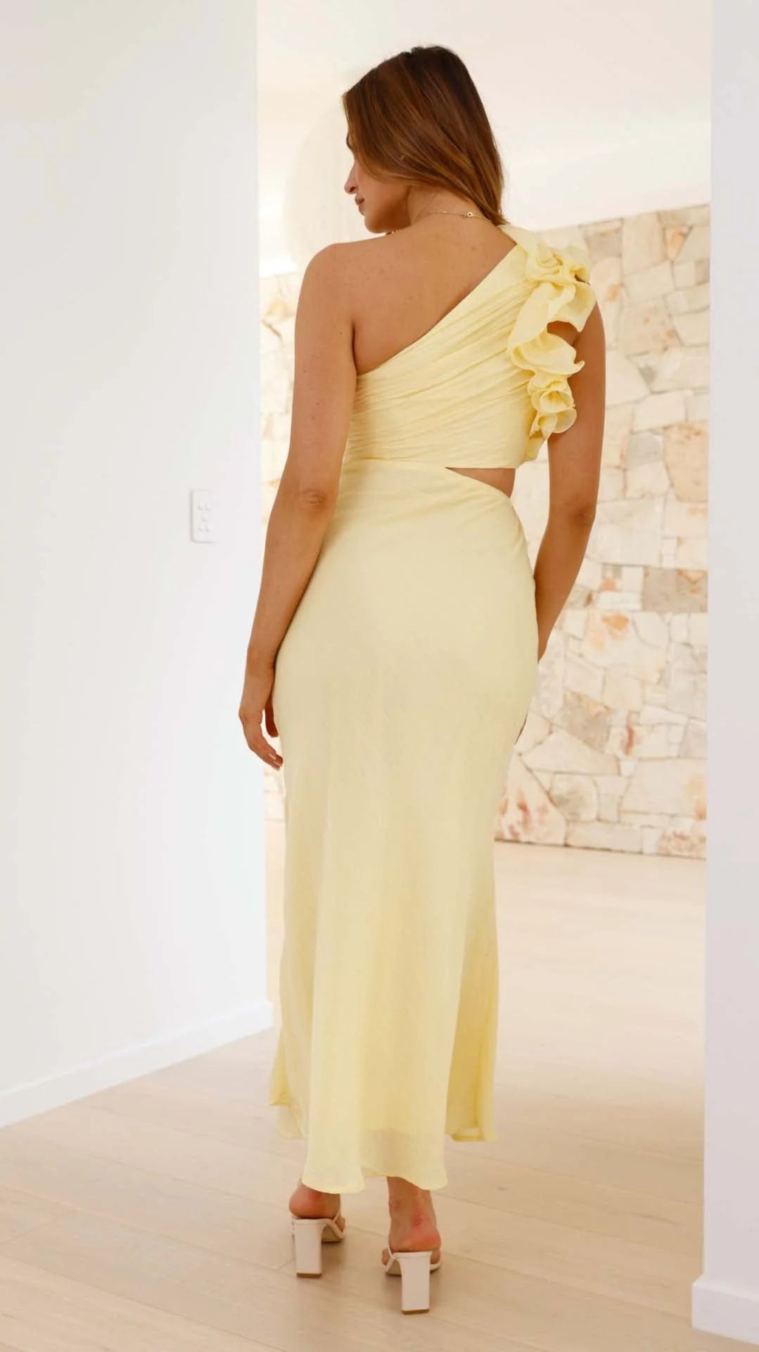 Yellow one-shoulder maxi dress with cutouts, features a sleek silhouette, perfect for any special occasion.