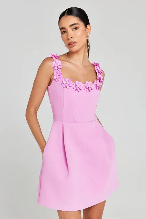 "Sleeveless pink dress with beautiful floral details, perfect for a chic and feminine look."
