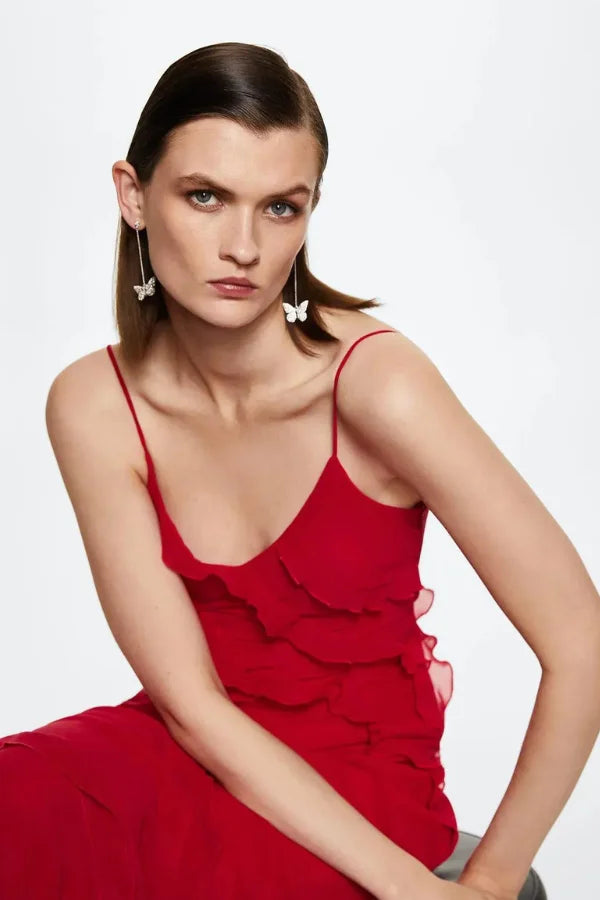 "Black spaghetti strap maxi dress with layered design, perfect for a casual yet sophisticated look."