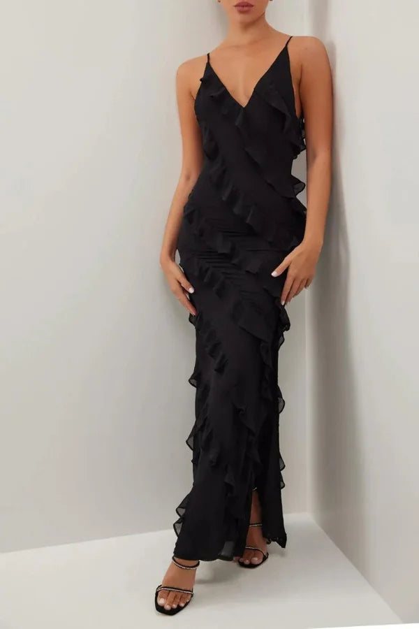 Black layered maxi dress with spaghetti straps, made from flowy fabric. Perfect for effortless chic summer style.