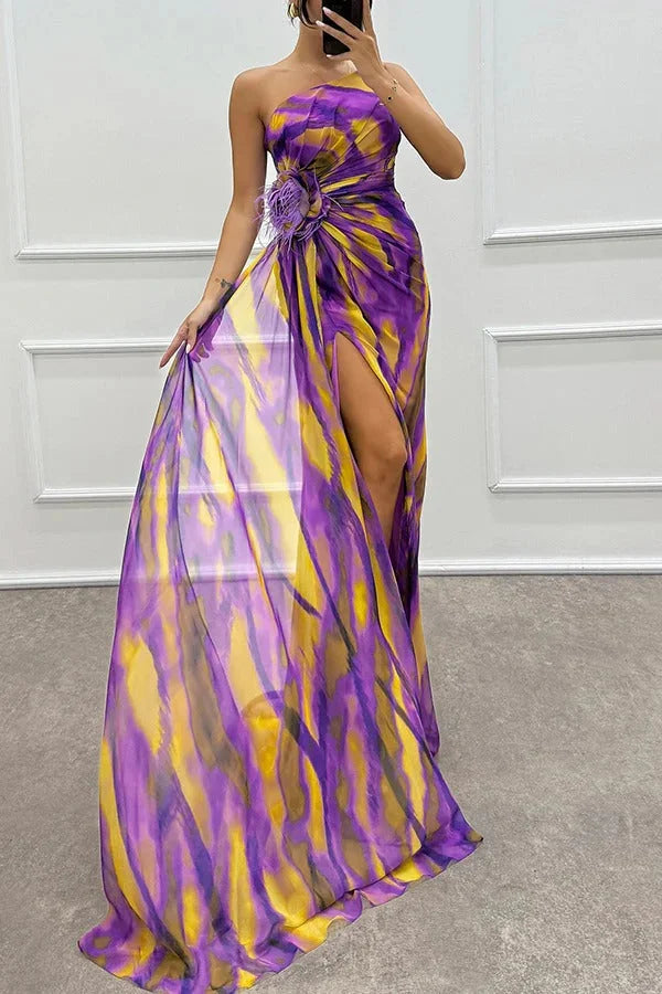 Strapless maxi dress with floral accent in soft chiffon fabric, perfect for summer events or casual outings.