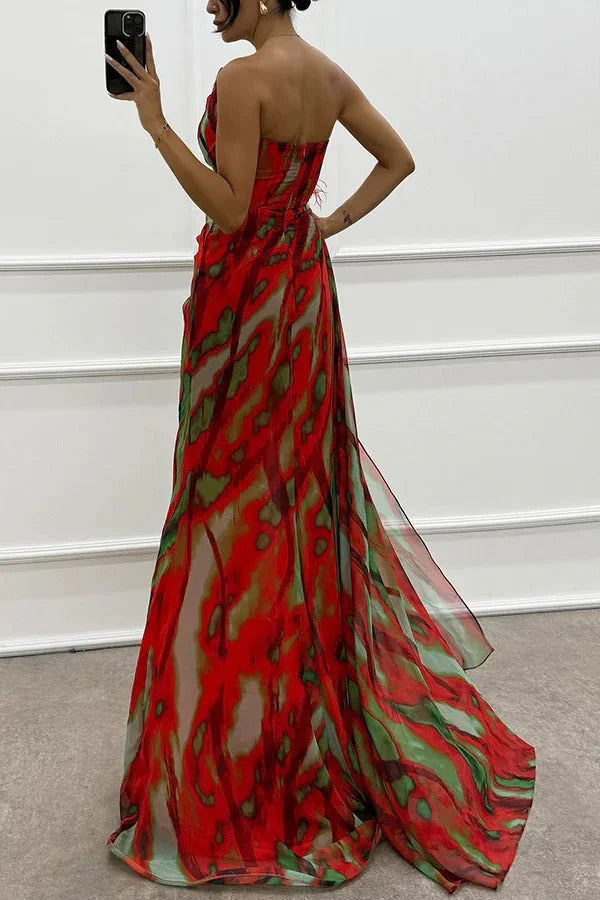 Strapless maxi dress crafted with flowing fabric, styled with a delicate floral accent.