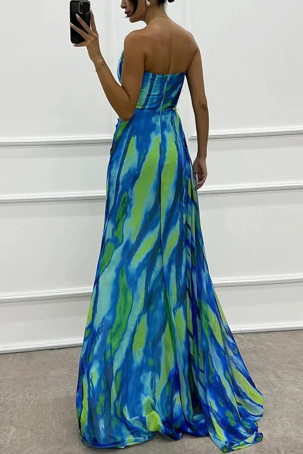 Strapless maxi dress in black with pink floral accent, made of lightweight chiffon fabric.