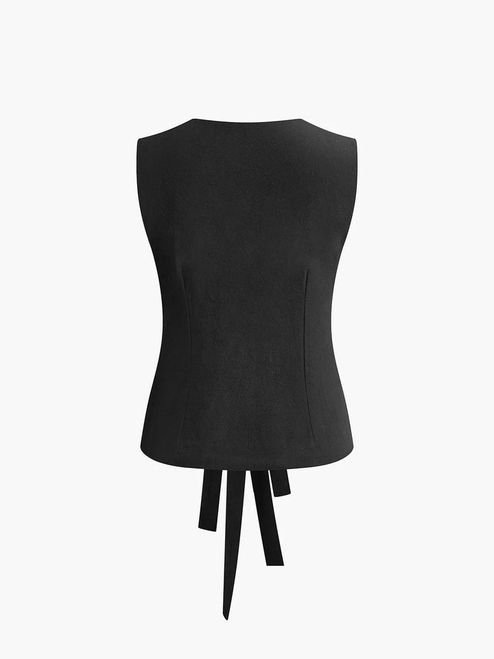 Sleeveless top with adjustable tie-back detailing, made of lightweight cotton blend fabric, perfect for summer dressing.