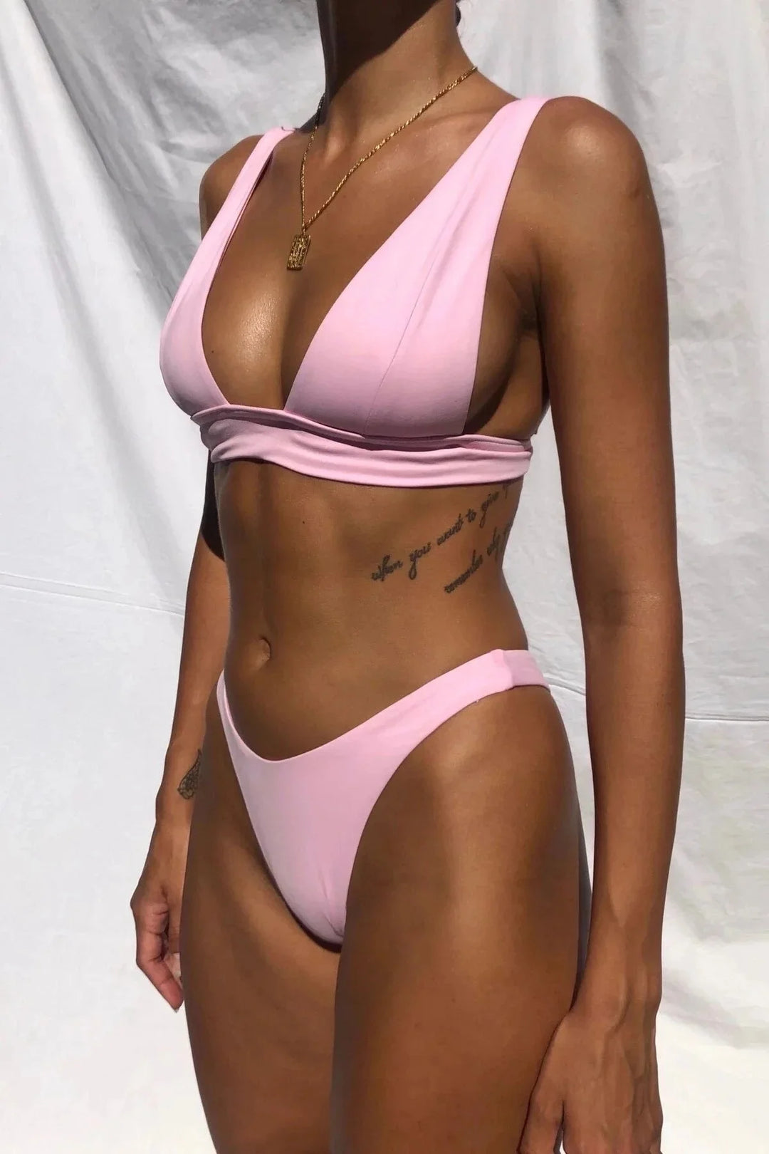 Aryanna push-up bikini set in black with high-rise bottoms, featuring ribbed fabric and adjustable straps for a flattering…
