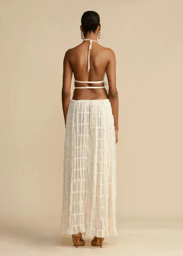 "Women's two-piece ivory skirt set featuring ruffled design and stylish silhouette, perfect for a chic and feminine look."