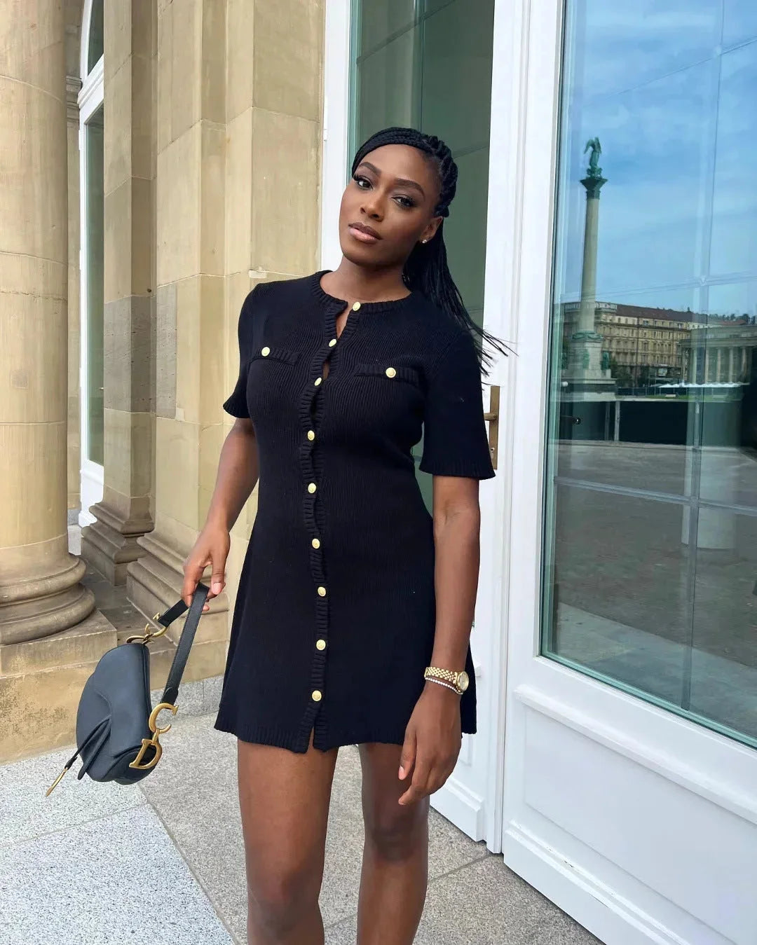 "Ribbed black mini dress with short sleeves, perfect for casual outings or date nights."