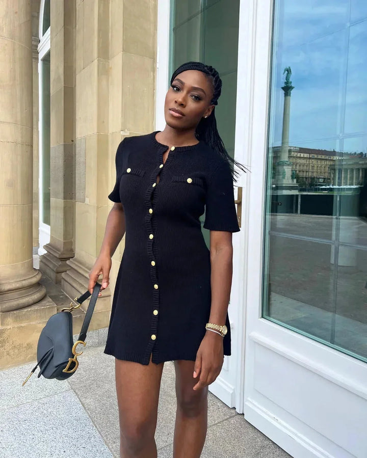 "Ribbed black mini dress with short sleeves, perfect for casual outings or date nights."