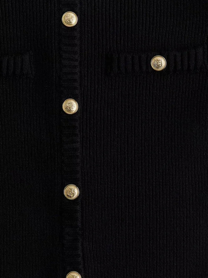 Short sleeve black ribbed mini dress with a flattering silhouette, ideal for casual or formal occasions.
