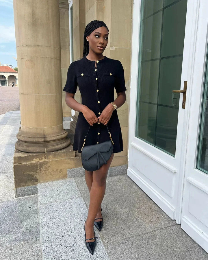 "Black ribbed mini dress with short sleeves, perfect for casual outings. Comfortable and stylish choice for everyday wear."