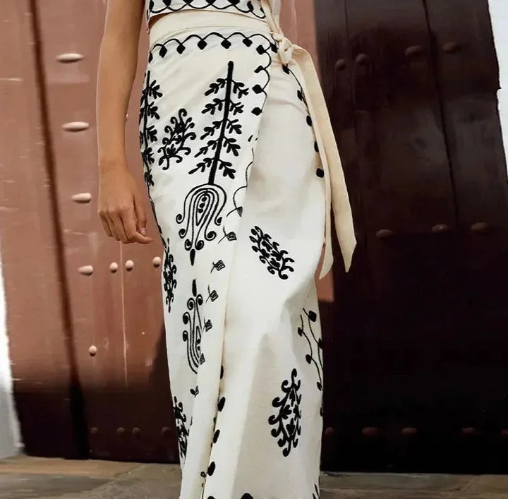 "Embroidered sleeveless top and flowing skirt set in light blue, perfect for summer outings"