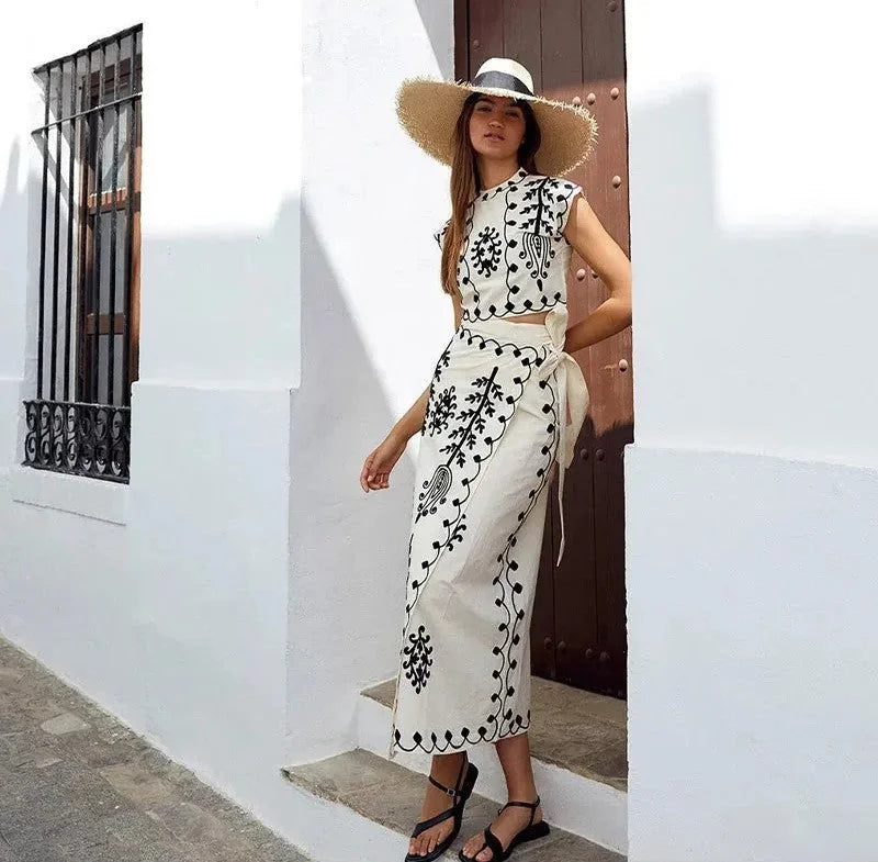 "Black sleeveless top and skirt set with intricate embroideries, ideal for formal occasions."