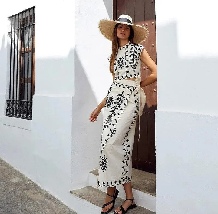 "Black sleeveless top and skirt set with intricate embroideries, ideal for formal occasions."