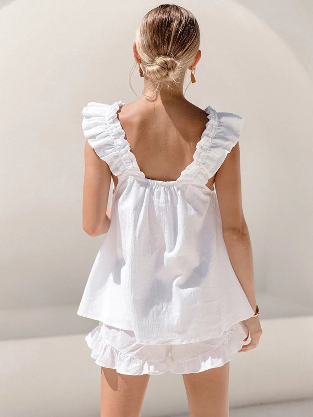 Navy blue ruffled sleeveless top with matching shorts set, ideal for casual summer days.