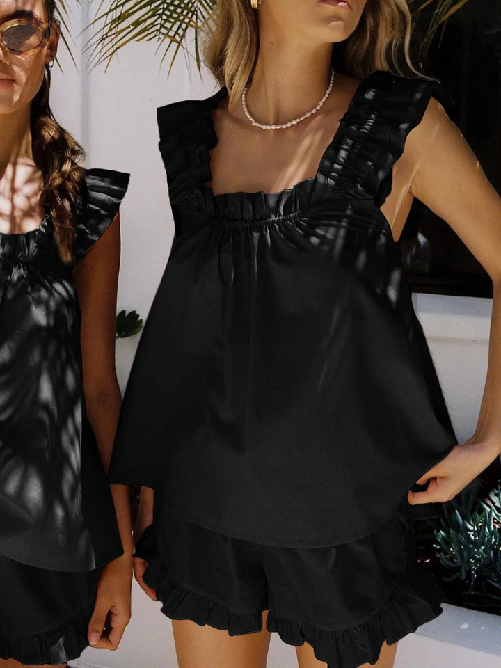 Black sleeveless ruffled top with matching shorts made from lightweight, breathable fabric for a chic coordinated outfit.