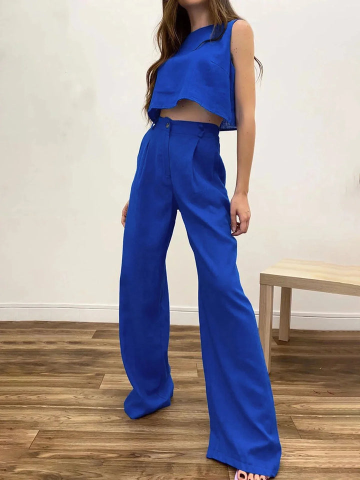 Blue asymmetrical crop top with wide-leg pants set. Made of soft cotton blend fabric. Stylish and comfortable outfit for…