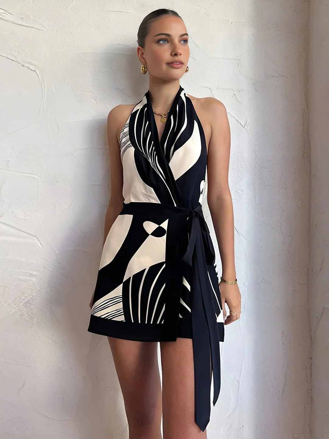 "Sleeveless monochrome wrap dress in soft cotton blend, featuring elegant V-neck and waist tie."