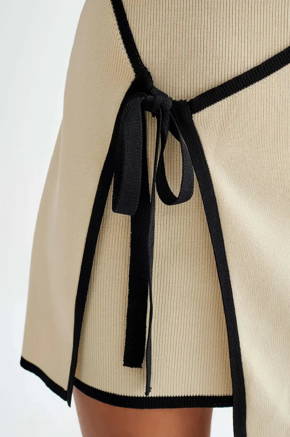 Strapless neutral mini dress in a soft and elegant fabric, perfect for any occasion.