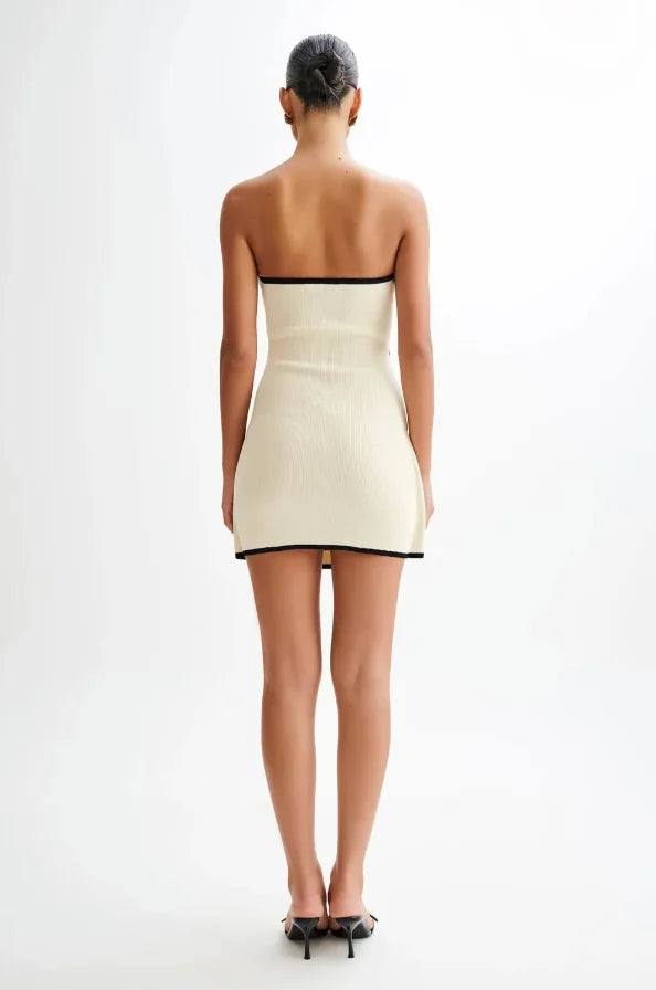 Strapless mini dress in neutral hue showing off a structured silhouette and tailored fit in a breathable cotton blend fabric.