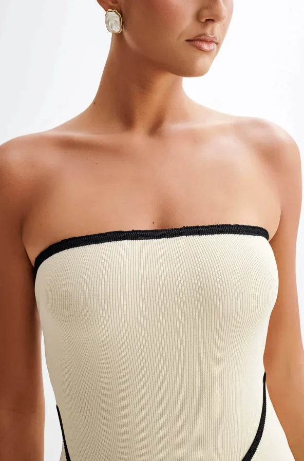 Strapless mini dress in neutral hue, featuring a fitted silhouette and a subtle sheen.