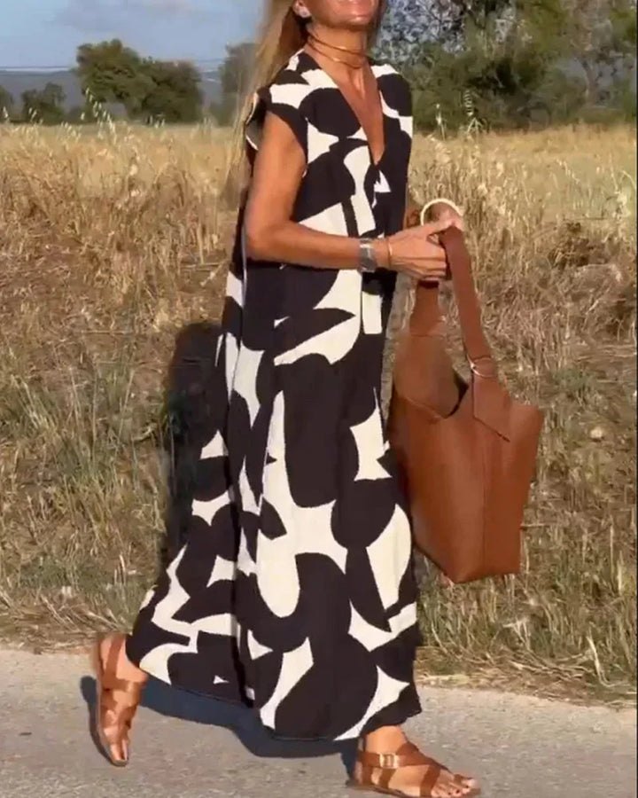 "Flowy V-neck maxi dress with bold patterns, perfect for a bohemian-inspired style. Made with lightweight, breathable…
