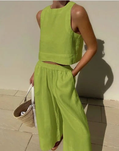 Green sleeveless top and flowing pants set named Audrie. Made from soft and breathable fabric, ideal for summer days or…