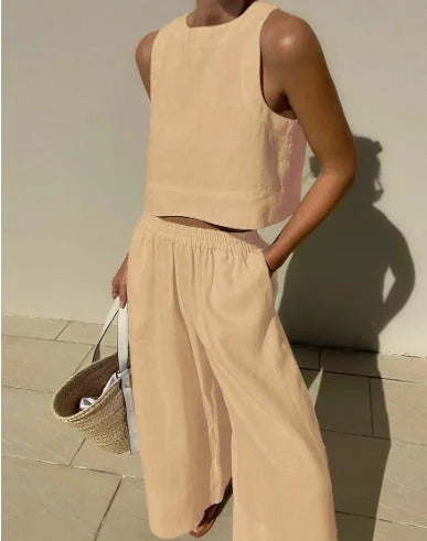 Khaki sleeveless top and flowing pants set in lightweight, breathable fabric with a relaxed fit and v-neck design.