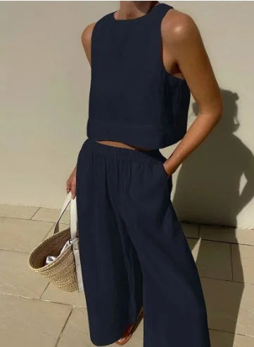 "Navy blue sleeveless top and flowing pants set, made in breathable fabric with a relaxed fit and stylish design for casual…