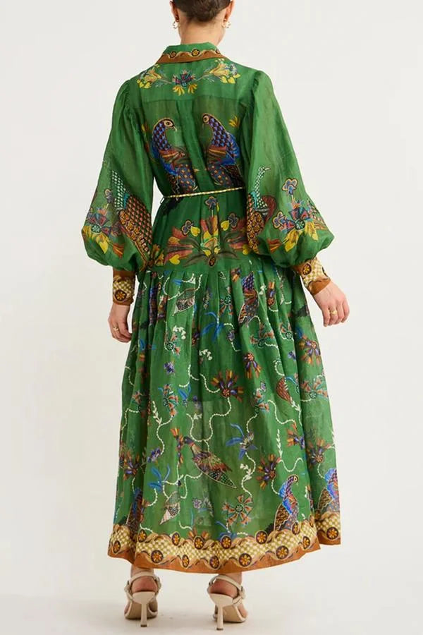 Green midi dress with bird print and sleeves. Made of soft and breathable fabric. Perfect for a casual yet stylish look.
